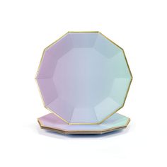 an empty plate on a white surface with gold trimmings and a pink base