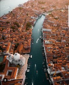 an aerial view of a city with boats in the water and buildings on both sides