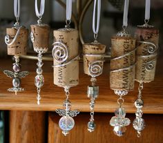 several wine corks with charms hanging from them