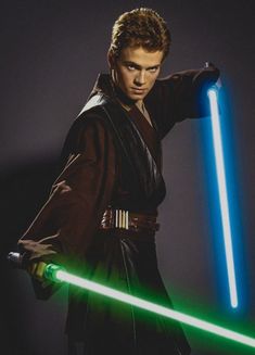 a young man holding a green light saber