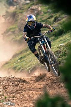 a man riding a bike down a dirt road