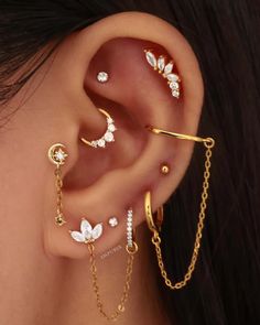 a woman wearing three different ear piercings