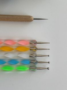 four different colored toothbrushes sitting next to each other on top of a table