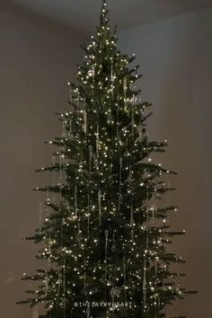 a christmas tree is lit up with white lights