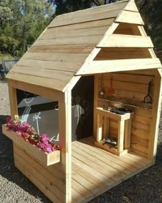 a small wooden structure with flowers in it