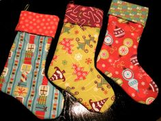 three christmas stockings sitting on top of a table