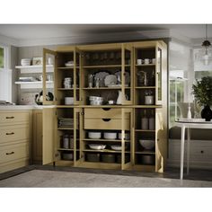 an open cabinet in the kitchen with dishes and utensils on it's shelves