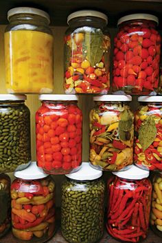 many jars filled with different types of vegetables