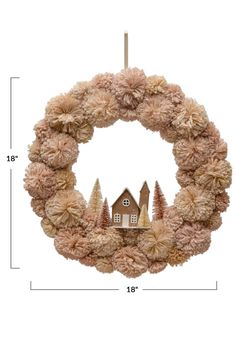 a wreath with a house and trees on it