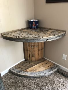 a table made out of wooden pallets with a bucket sitting on top of it