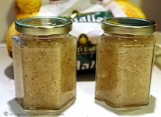 two jars filled with food sitting on top of a table