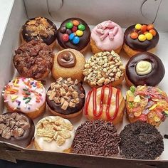 a box filled with lots of different flavored donuts