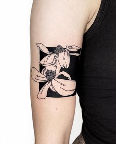 a woman's arm with a flower tattoo on the left side of her arm