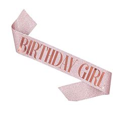 a pink ribbon with the words birthday girl printed on it and an arrow in the middle