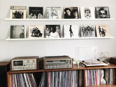 there are many records on the shelves in this room and one is stereo tape recorder