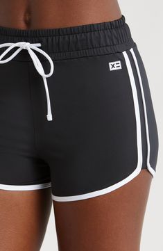 You will move with ease from land to sea in these stretch-enhanced swim shorts topped with a high waist. 3 1/2" inseam   Lined   80% recycled polyester; 20% spandex   Hand wash, line dry   Imported Sporty Black Swimwear With Built-in Shorts, Athleisure Swimwear With Built-in Shorts, Sporty Short Swim Skirt With Moisture-wicking, Summer Swim Skirt For Gym With Short Length, Sporty Moisture-wicking Swim Skirt For Swimming, Black Beachwear Activewear, Athleisure Shorts With Contoured Waistband For Summer, Sporty Stretch Activewear For Vacation, Black Swimwear For Gym With Short Length