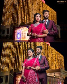 two people standing next to each other in front of a building with lights on it