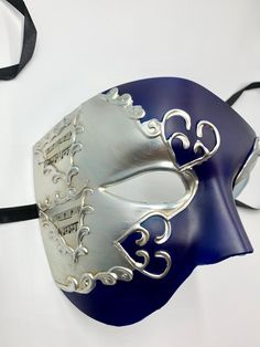 This is a stunning half face phantom masquerade mask with very venetian and phantom design embellishments, The mask has navy blue color in the middle decorated with distressed silver.It has a very elegant mysterious look. In my store I have other half face masquerade masks that you might like and laser cut masks with different colors and designs and different color of gems. I also have machine embroidered masquerade masks that color of threads and gems can be changed, I have masks with stick and Mascarade Mask Navy, Silver Masks And Prosthetics For Mardi Gras Theater, Venetian Silver Mask For Theater, Silver Venetian Mask For Theater, Silver Venetian Masks For Theater, Blue Halloween Masquerade Mask, Blue Masquerade Mask For Halloween, Blue Venetian Mask For Carnival, Silver Masquerade Mask For Mardi Gras Theater