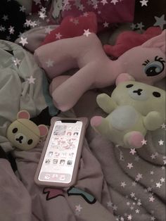 there is a remote control on the bed with stuffed animals and stars all over it