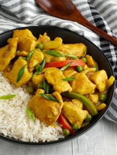 a black bowl filled with rice and chicken