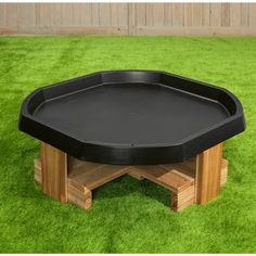 a black table sitting on top of green grass