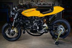 a yellow motorcycle is parked in a garage