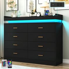 a black dresser with blue light under it