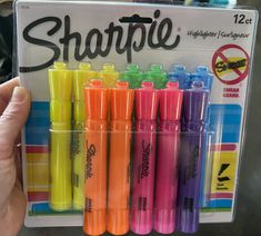 a person holding a box of sharpie highlighters