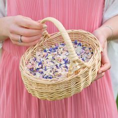 a person holding a wicker basket filled with confetti sprinkles