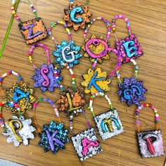 the letters and numbers are made out of polymer beads, beaded with colorful thread