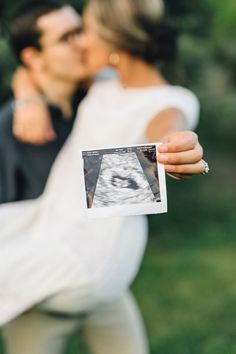 a man and woman kissing in front of an instagramr with the same photo