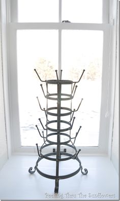 a metal rack sitting on top of a window sill in front of a white wall