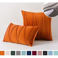 two orange pillows sitting next to each other