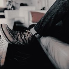 a man sitting on top of a white couch