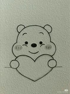 a drawing of a teddy bear holding a heart on a white paper with black outline