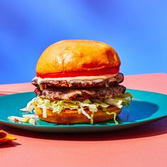 a hamburger sitting on top of a blue plate