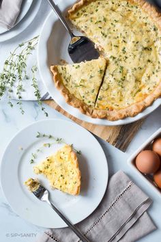 an egg pie on a plate with a slice cut out and eggs in the background