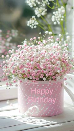 pink and white flowers in a polka dot birthday bucket