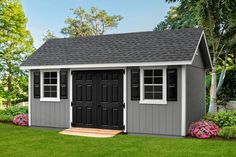 a small gray shed with black doors and windows on the side of it, surrounded by green grass