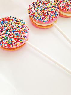 three donuts with sprinkles on top of them