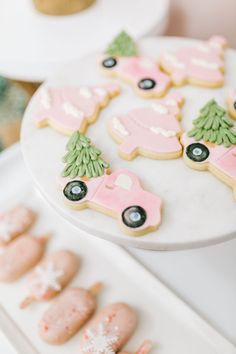 decorated cookies are displayed on trays next to other decorations and decorating items in the background