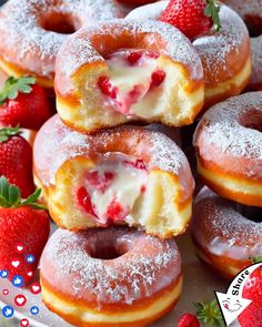 strawberry cream filled donuts stacked on top of each other with strawberries around them