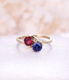 Ruby engagement ring Sapphire engagement ring 14K rose Gold vintage rings woman Wedding Unique Jewelry birthstone Anniversary gift for her All our diamonds are 100% natural and not clarity enhanced or treated in anyway. We only use conflict-free diamonds and gemstones. - Vintage style Ruby and moonstone ring - Natural Conflict free diamonds - comfortable band Lab Ruby Size: 6mm Lab Sapphire Size: 6mm Side sotnes: Natural diamond Weight - approx 0.02CT*3 Clarity - VS-SI Color- H/white Cut - VG - Ruby And Sapphire Engagement Ring, Ruby Sapphire Ring, Round Birthstone Ring With Prong Setting For Anniversary, Round Birthstone Anniversary Ring With Prong Setting, Round Cut Sapphire Proposal Ring, Round Cut Ruby Ring With Accent Stones For Anniversary, Red Sapphire Ring With Round Cut For Anniversary, Diamond Birthstone Ring For Proposal, Red Round Cut Sapphire Ring For Anniversary