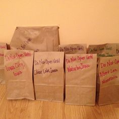 five brown bags with writing on them sitting on the floor in front of a wall that says diy travel bag supplies