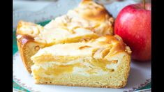 two pieces of cake on a plate next to an apple