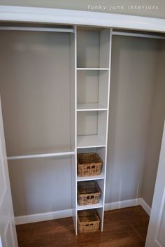 an empty closet with white shelves and baskets