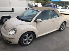 a small white car parked in a parking lot