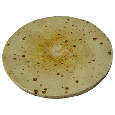 a white plate with brown speckles on it