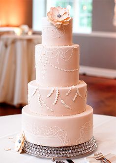 a three tiered wedding cake sitting on top of a table