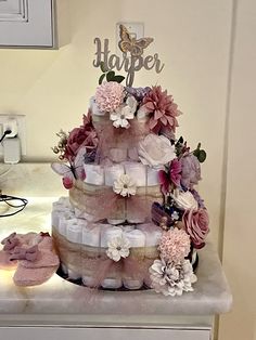 there is a cake made out of diapers and flowers